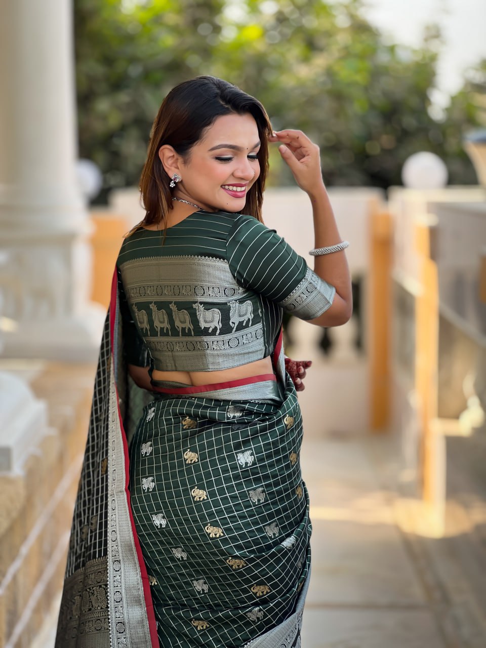 Elegant Bottle Green Silk Saree with Silver-Gold Zari Animal Motifs